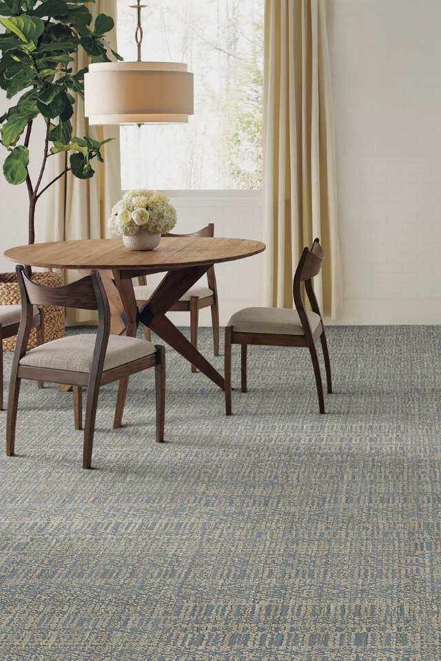 patterned loop pile carpet in modern dining room with big plant